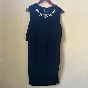 Elegant Black Sleeveless Dress with Statement Necklace